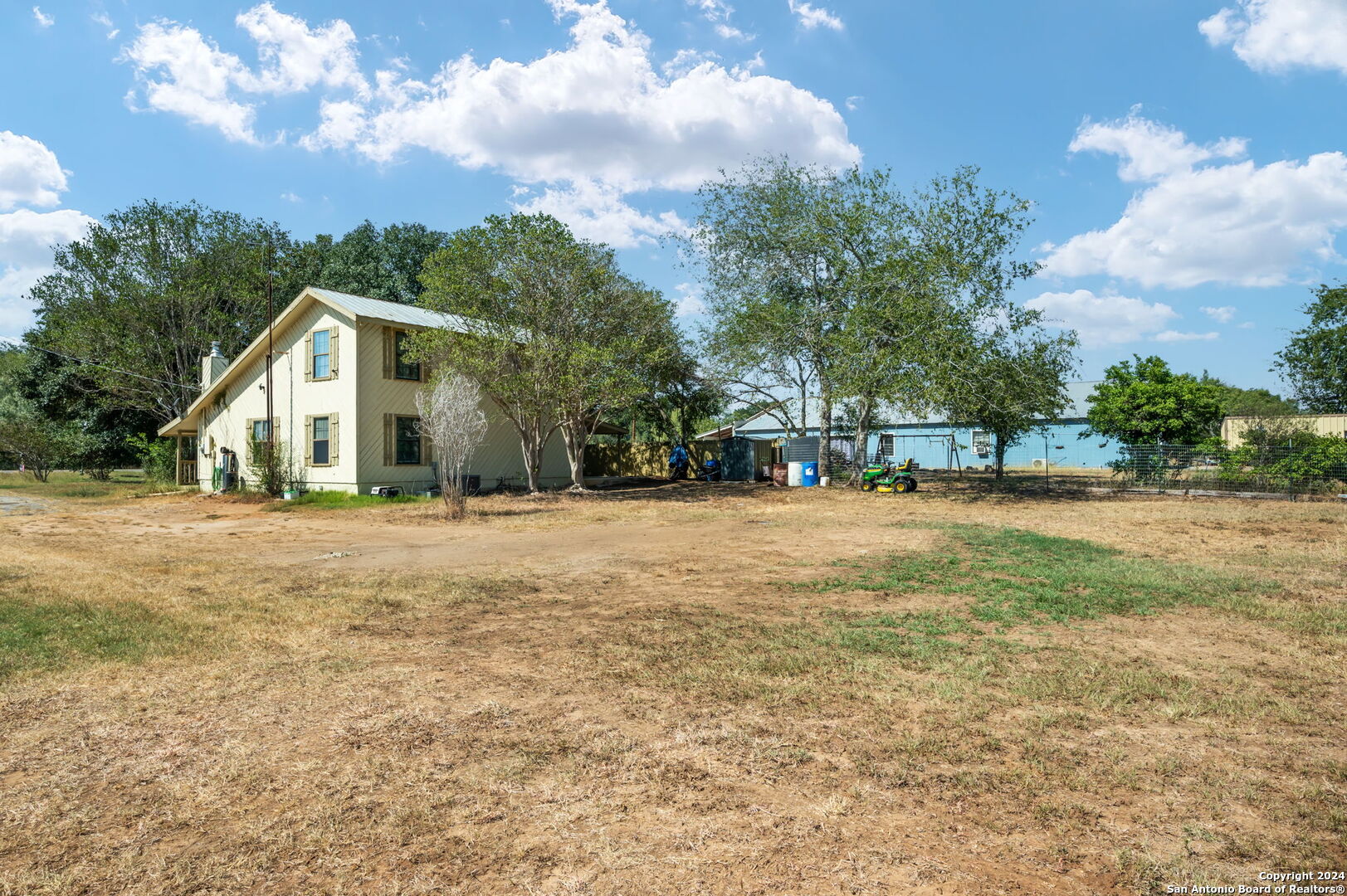 795 Highway 16 Jourdanton, TX 78026 - Photo 8 of 25 a front view of house with yard and green space