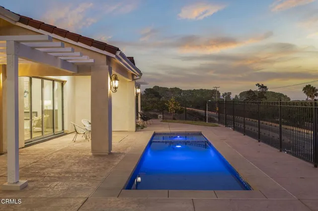 a kitchen with kitchen island granite countertop a sink a counter space appliances and cabinets
