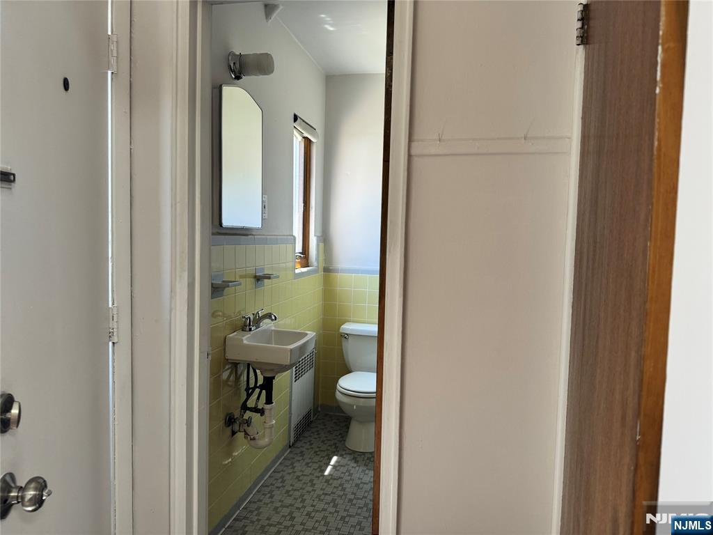 251 Fort Lee Road, Unit D Teaneck, NJ 07666 - Photo 6 of 14 a bathroom with a sink a toilet and shower
