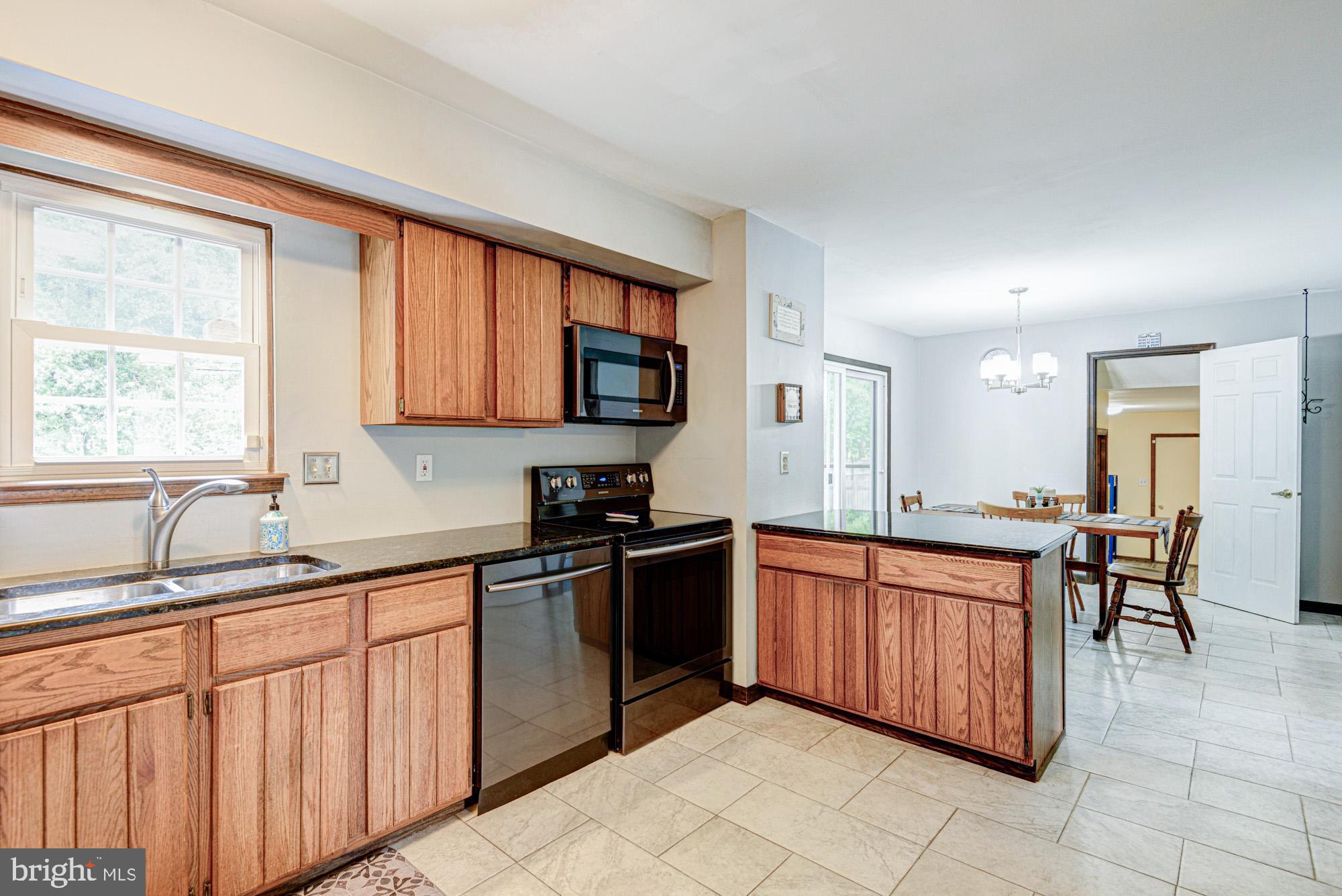 8 Risa Court Newark, DE 19702 - Photo 33 of 58 a kitchen with stainless steel appliances granite countertop a sink and cabinets
