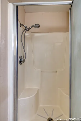 a bathroom with a shower and a bath tub