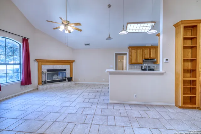 a view of a hallway with a chandelier and fireplace