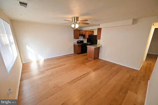 a view of a kitchen with a sink and a window