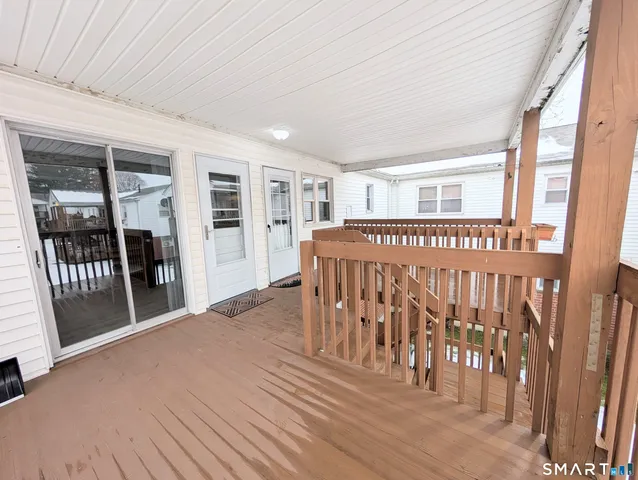 a view of a porch with wooden floor and outdoor space