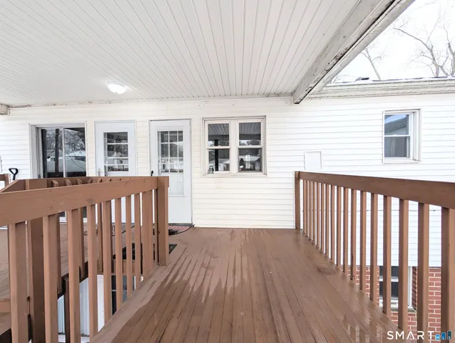 a view of a house with wooden deck