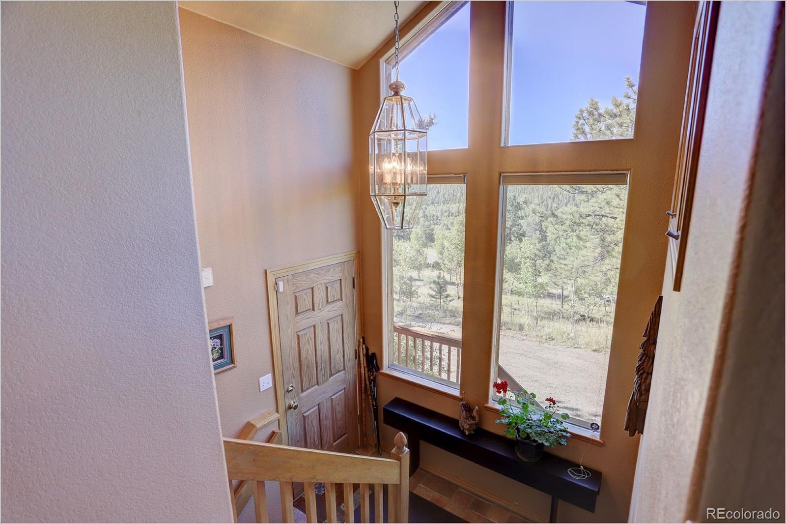 109 Royal Ridge Drive Bailey, CO 80421 - Photo 23 of 39 a view of a front door and deck