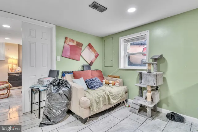 a bedroom with furniture and a painting