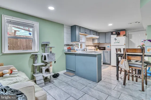 a kitchen with stainless steel appliances kitchen island granite countertop a sink and cabinets
