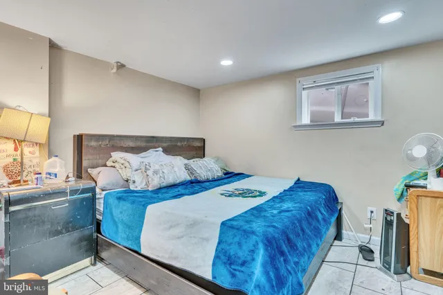 a bedroom with a bed and painting on the wall