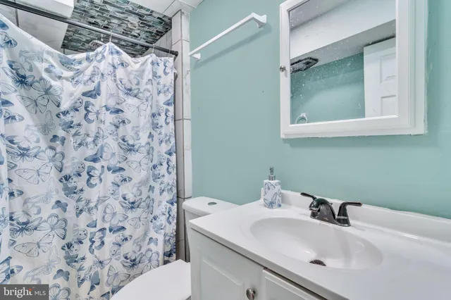 a bathroom with a sink toilet and mirror