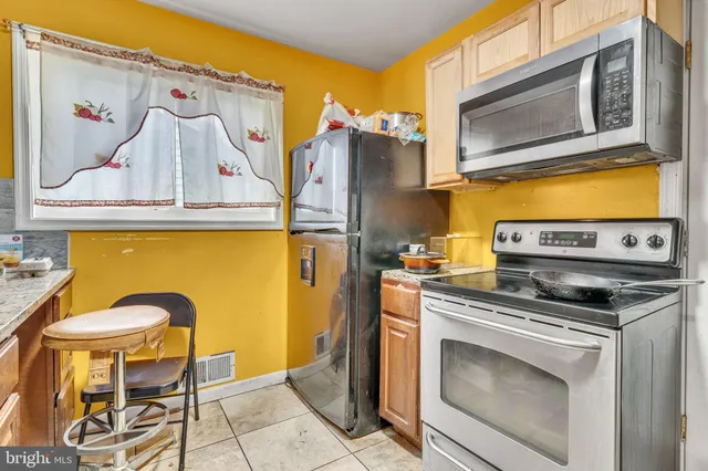 a kitchen with a stove and a microwave