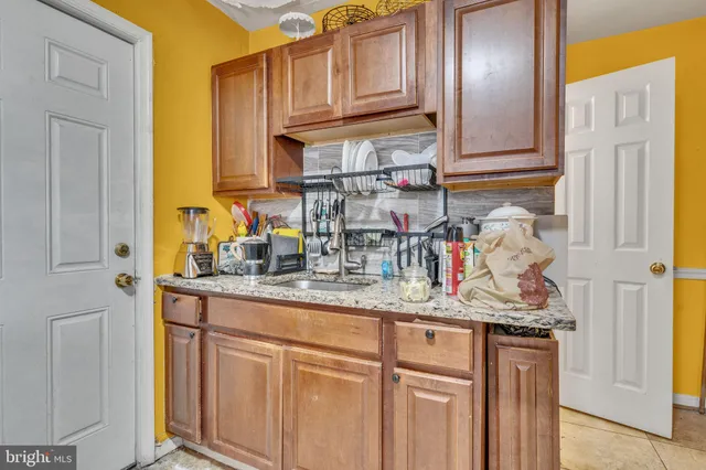 a kitchen with stainless steel appliances granite countertop a sink and cabinets