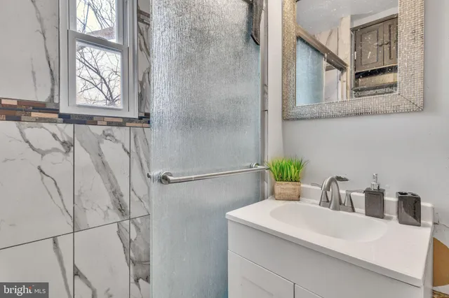a bathroom with a sink and mirror