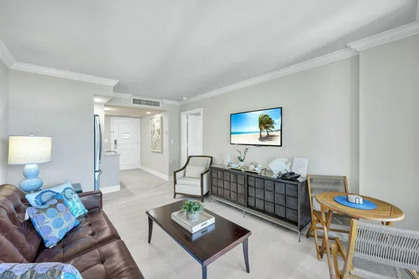 a living room with furniture a rug and a table