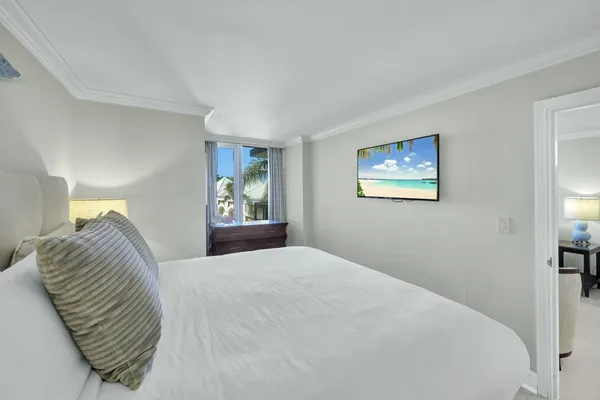 a bedroom with a bed and a painting on the wall