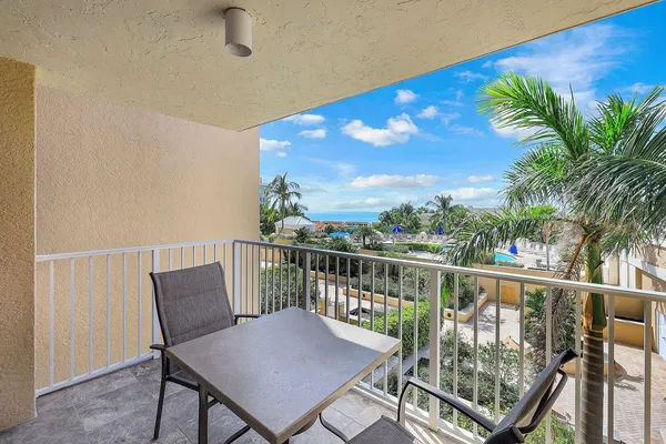a view of a balcony with furniture