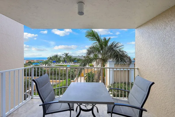 a view of a balcony with lake view and sitting space