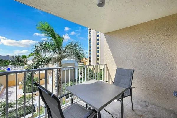 a view of a balcony with furniture