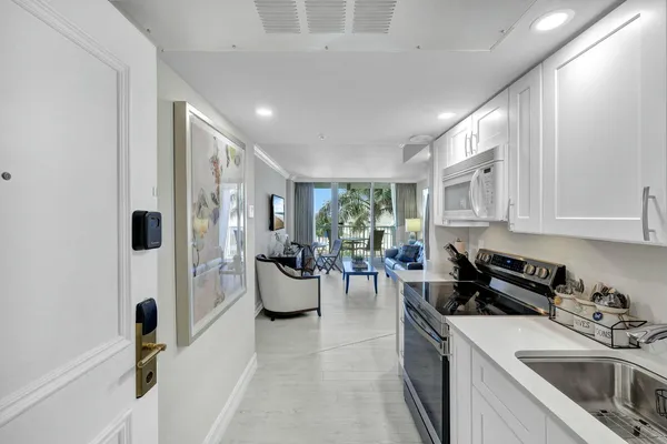 a kitchen with a sink stainless steel appliances and cabinets