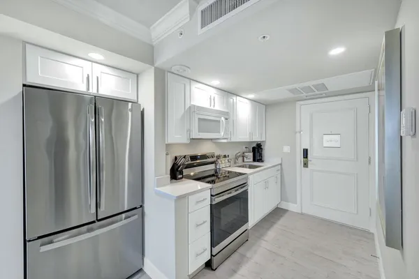 a kitchen with a stove sink and refrigerator