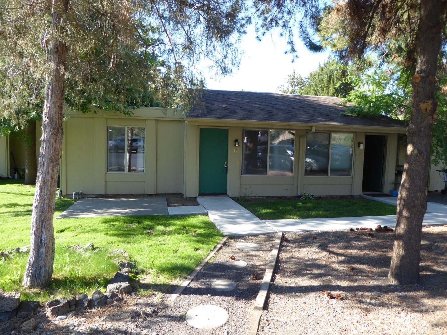 1700 Northeast Wells Acres Road, Unit 15 Bend, OR 97701 - Photo 1 of 17 Front of condo, patio and lawn