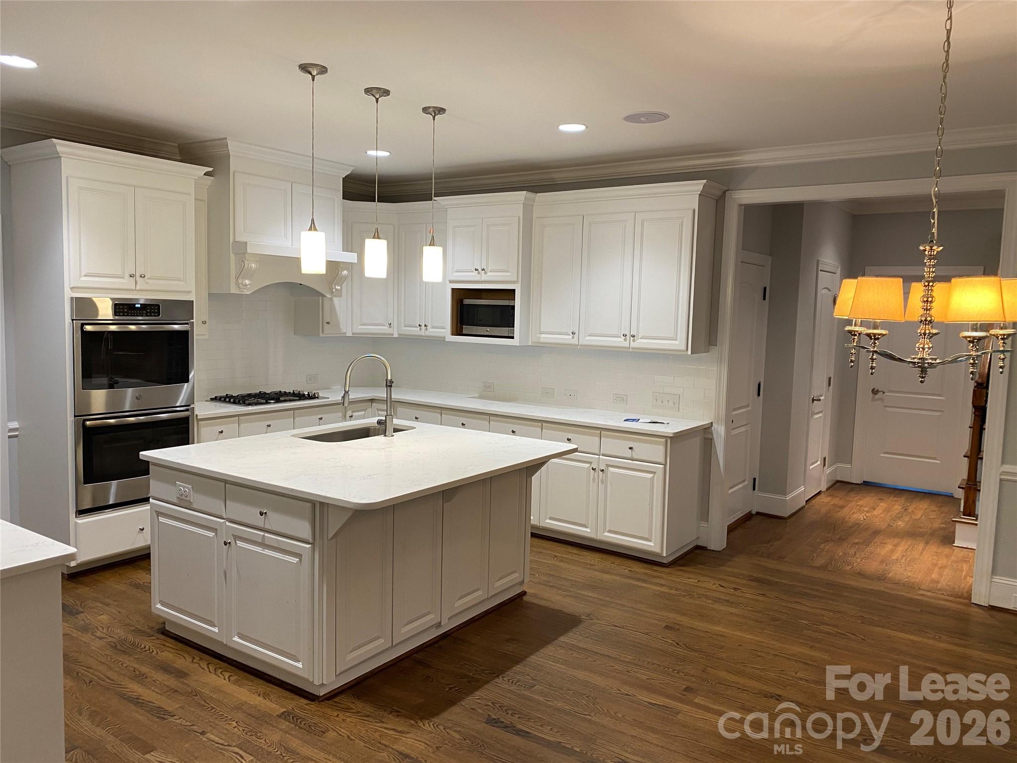 5520 Providence Road Charlotte, NC 28226 - Photo 4 of 6 a kitchen with a stove window and wooden floor