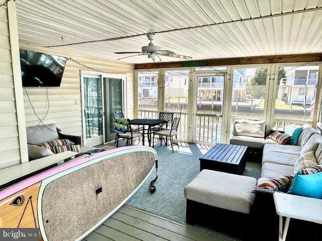 a view of a patio with table and chairs and wooden floor