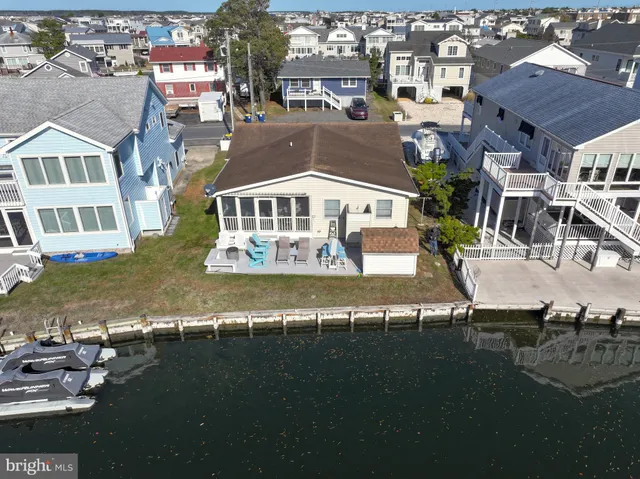 an aerial view of residential houses with outdoor space and swimming pool