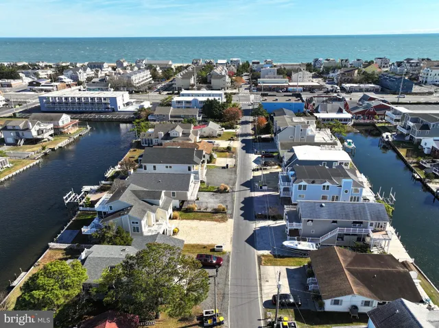an aerial view of a city with lots of residential buildings and ocean view