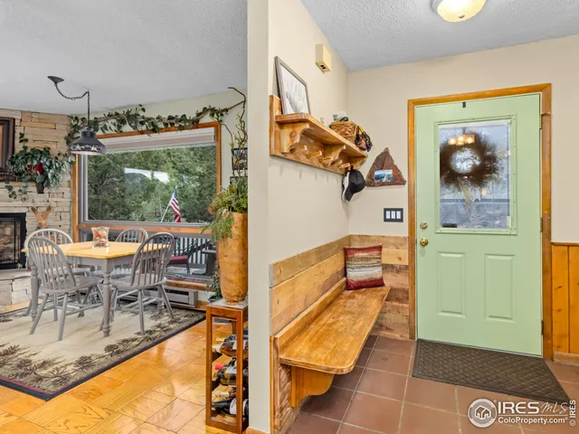 a dining room with furniture and a floor to ceiling window