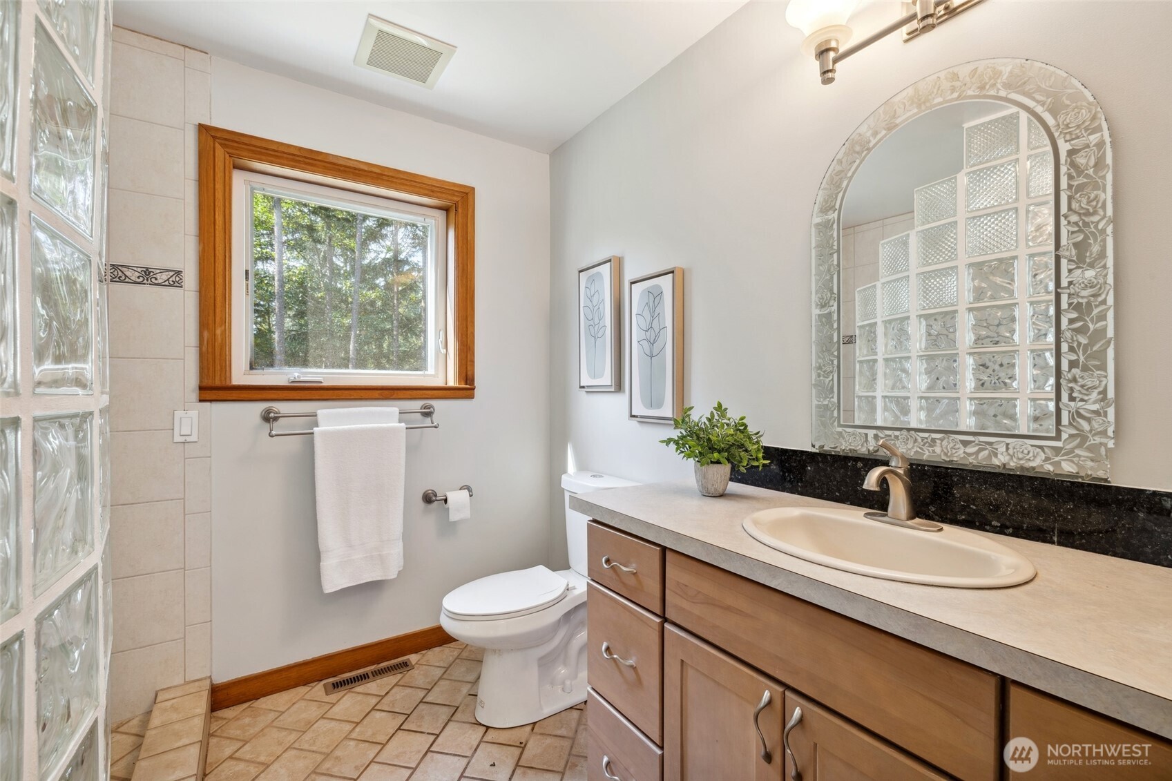 4987 Mutiny Bay Road Freeland, WA 98249 - Photo 19 of 40 a bathroom with a sink a toilet and a window