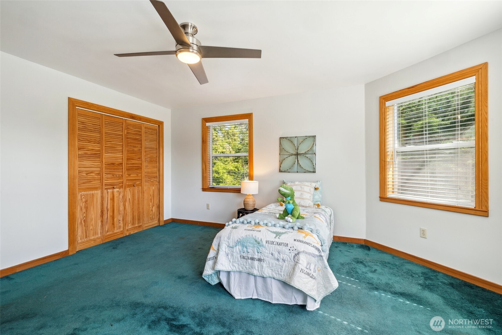 4987 Mutiny Bay Road Freeland, WA 98249 - Photo 22 of 40 a bedroom with a bed table flowerpot and window