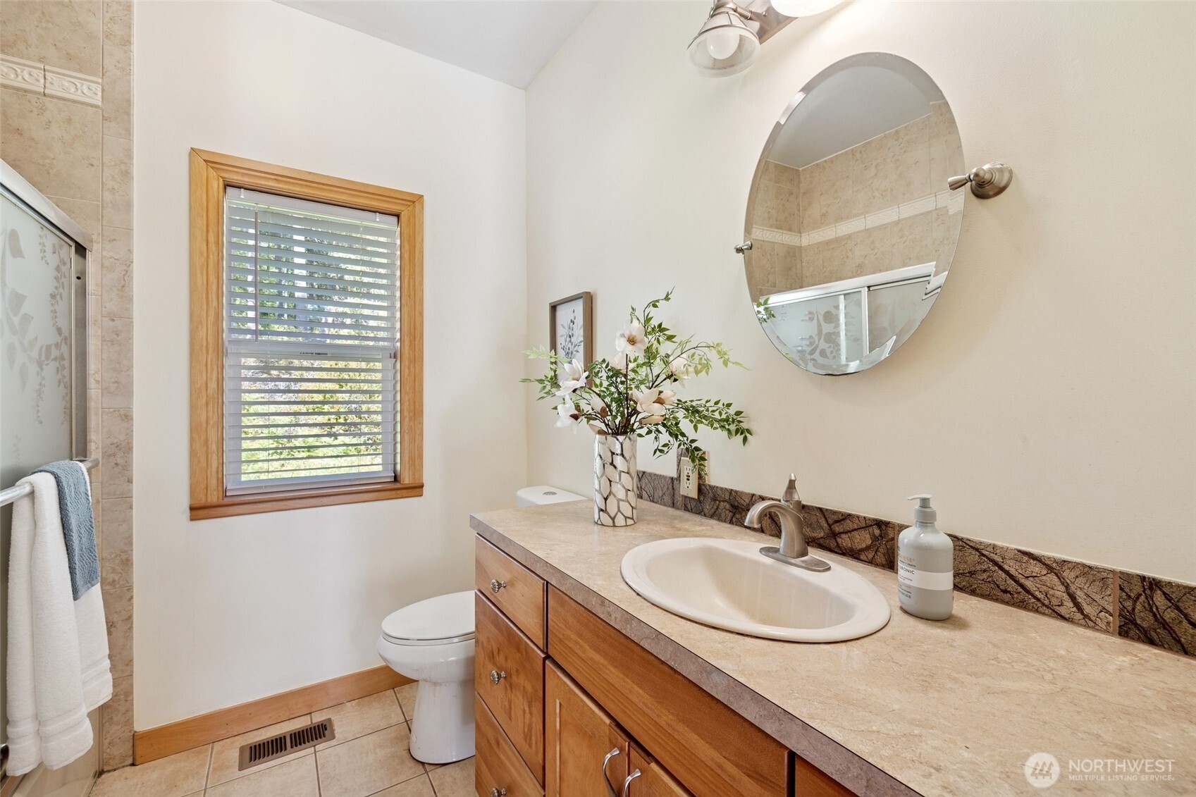 4987 Mutiny Bay Road Freeland, WA 98249 - Photo 25 of 40 a bathroom with a granite countertop sink and a mirror