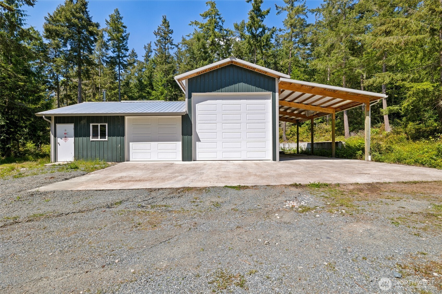 4987 Mutiny Bay Road Freeland, WA 98249 - Photo 31 of 40 a front view of a house with a yard and garage