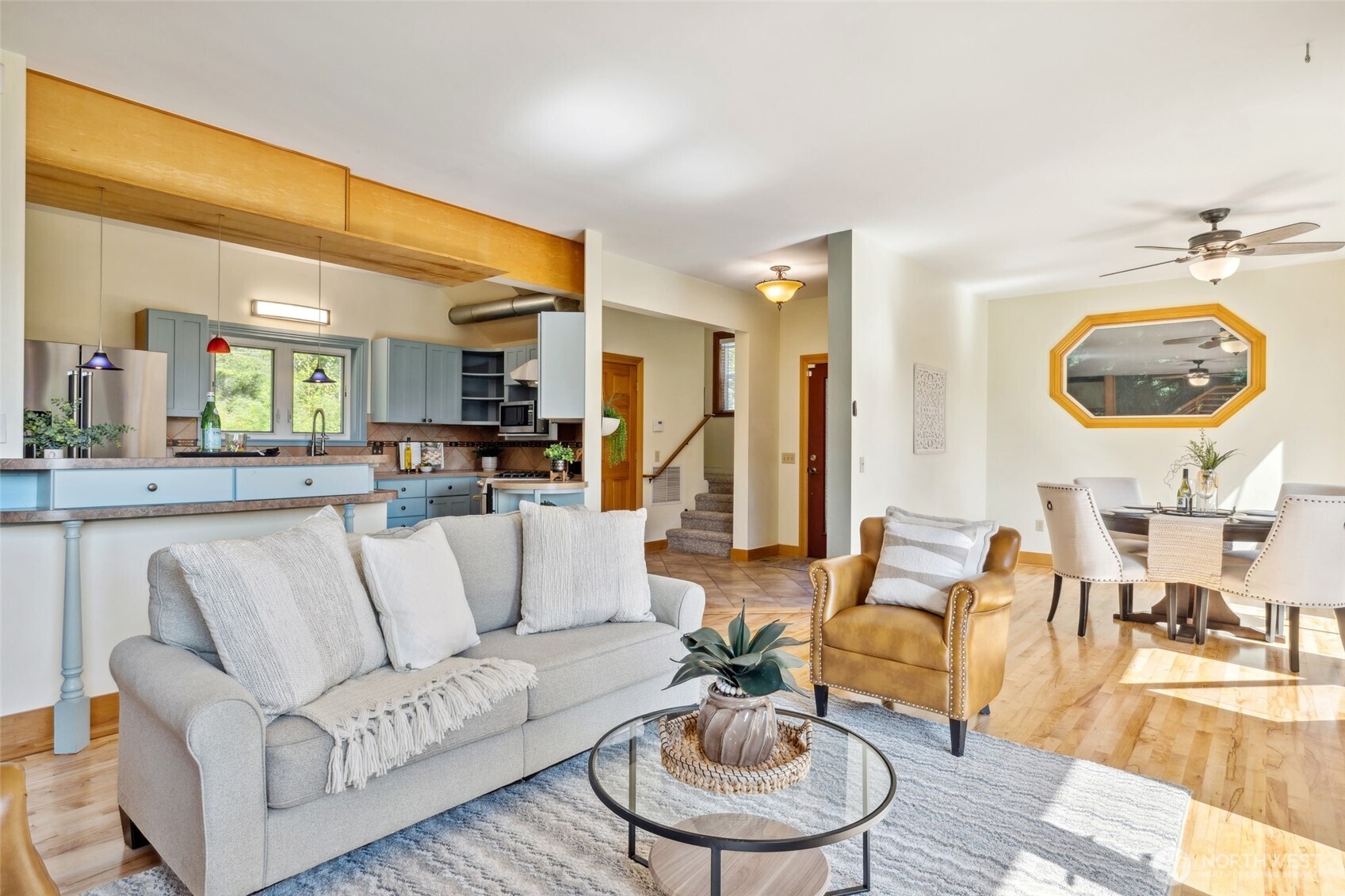 4987 Mutiny Bay Road Freeland, WA 98249 - Photo 7 of 40 a living room with furniture and a dining table with wooden floor