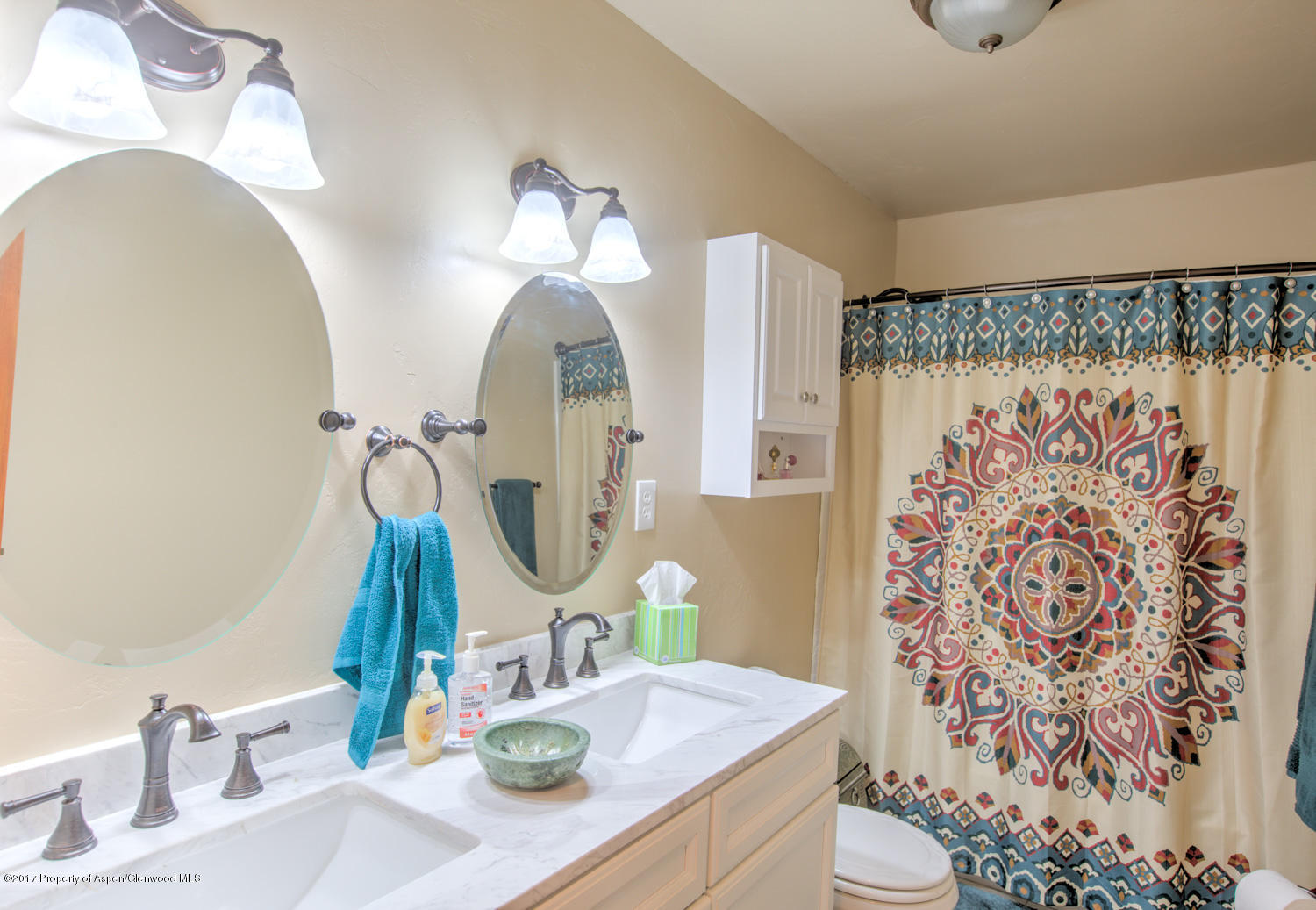 875 East 7th Street Rifle, CO 81650 - Photo 9 of 27 a bathroom with a sink a toilet and a mirror