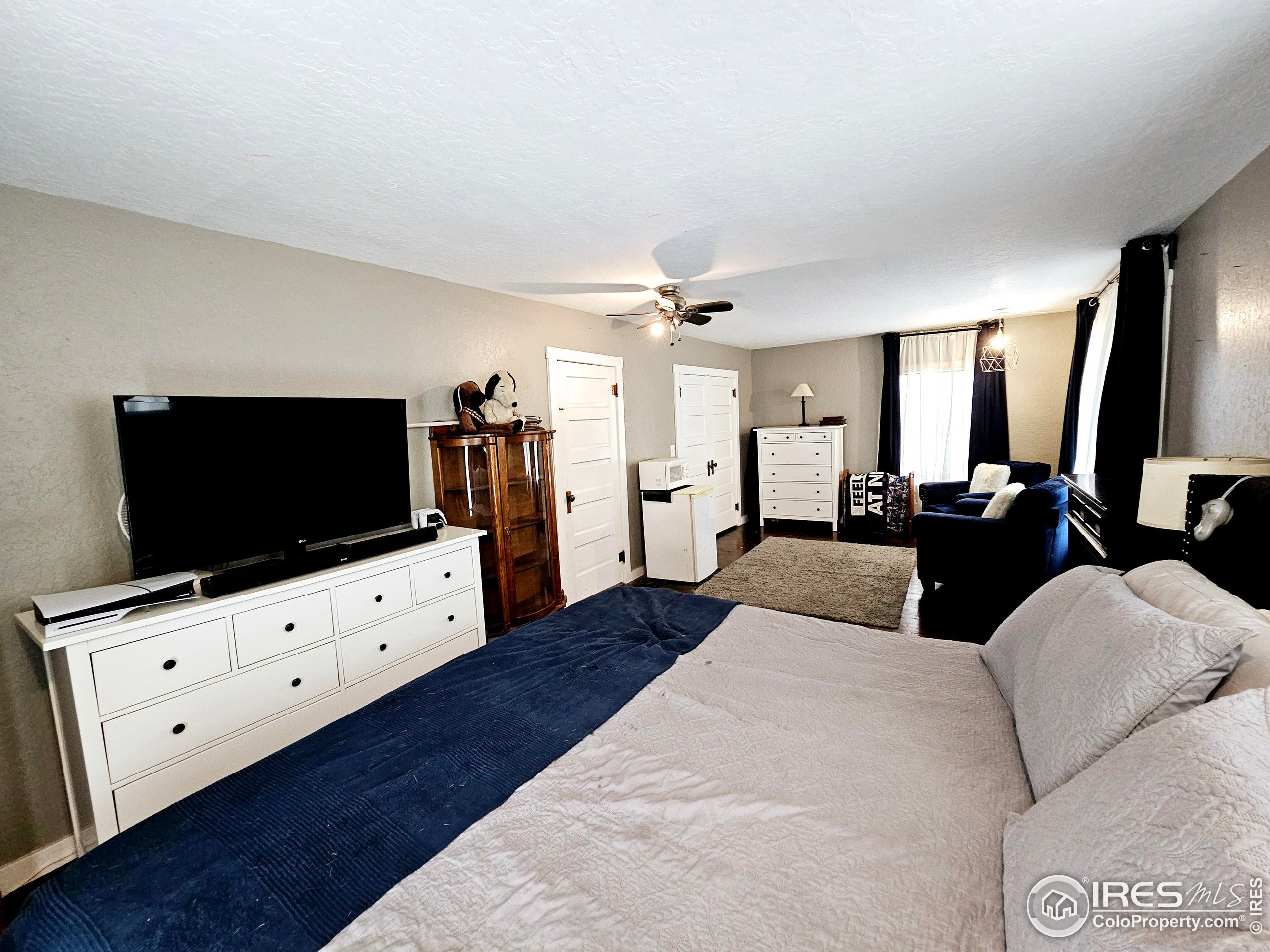 704 South 3rd Avenue Sterling, CO 80751 - Photo 19 of 35 a living room with furniture and a flat screen tv