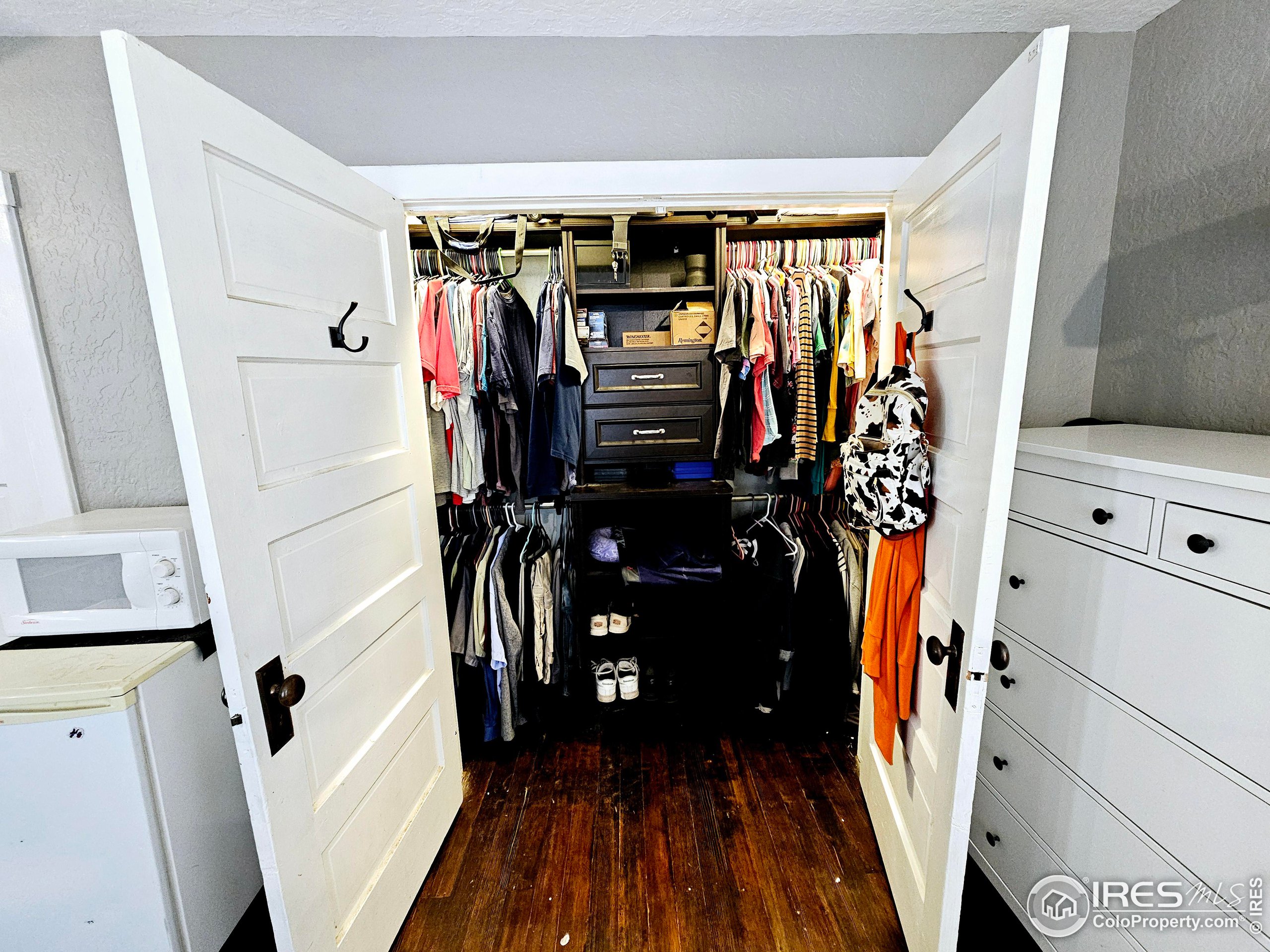 704 South 3rd Avenue Sterling, CO 80751 - Photo 20 of 35 a view of walk in closet with clothes and shoes