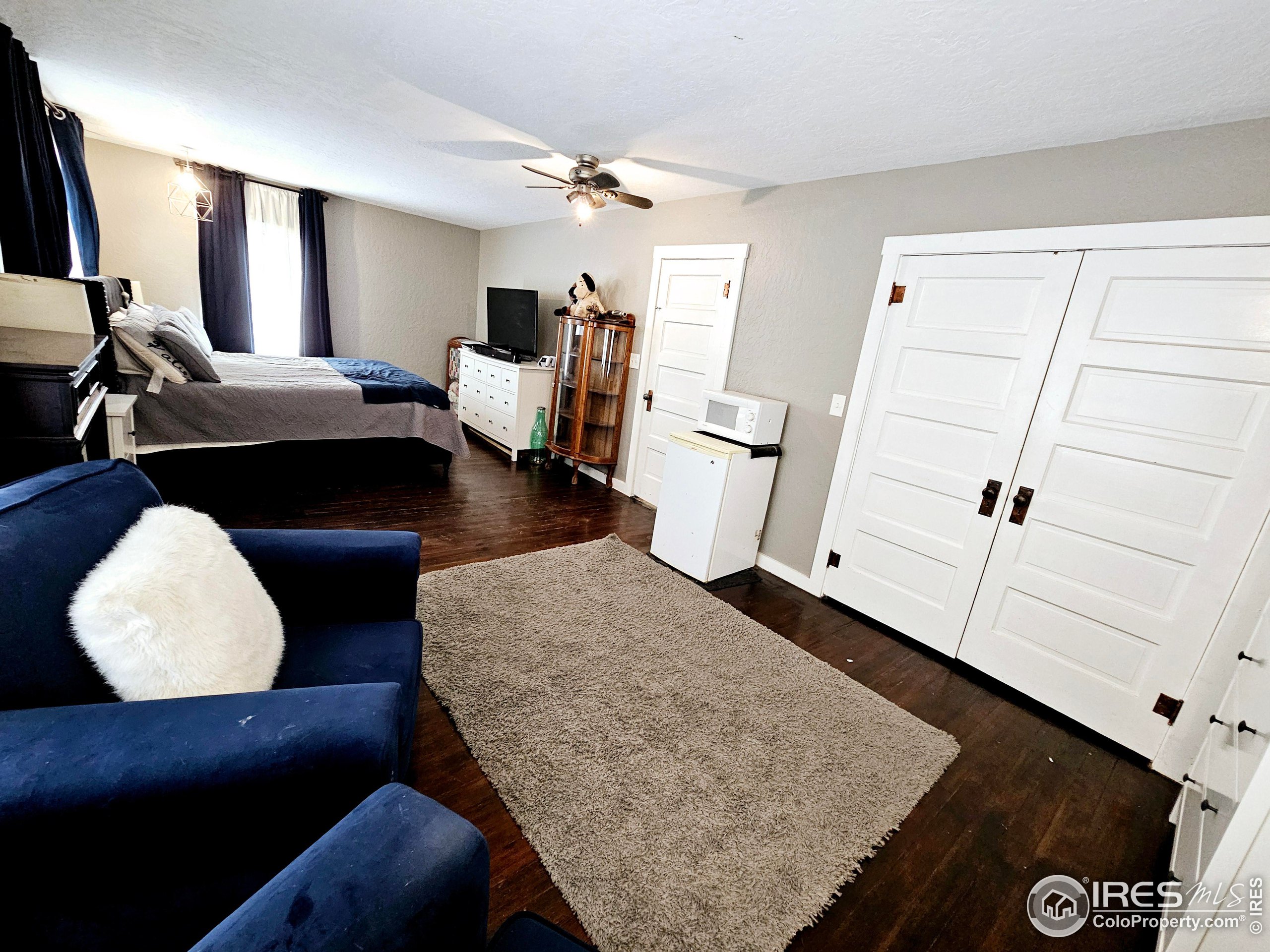 704 South 3rd Avenue Sterling, CO 80751 - Photo 21 of 35 a living room with furniture and a rug