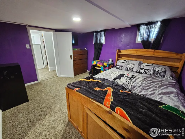 a bed room with furniture and a lamp