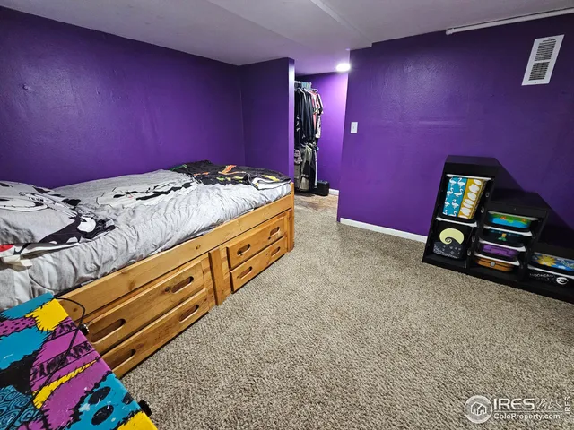 a bedroom with a bed and a mirror