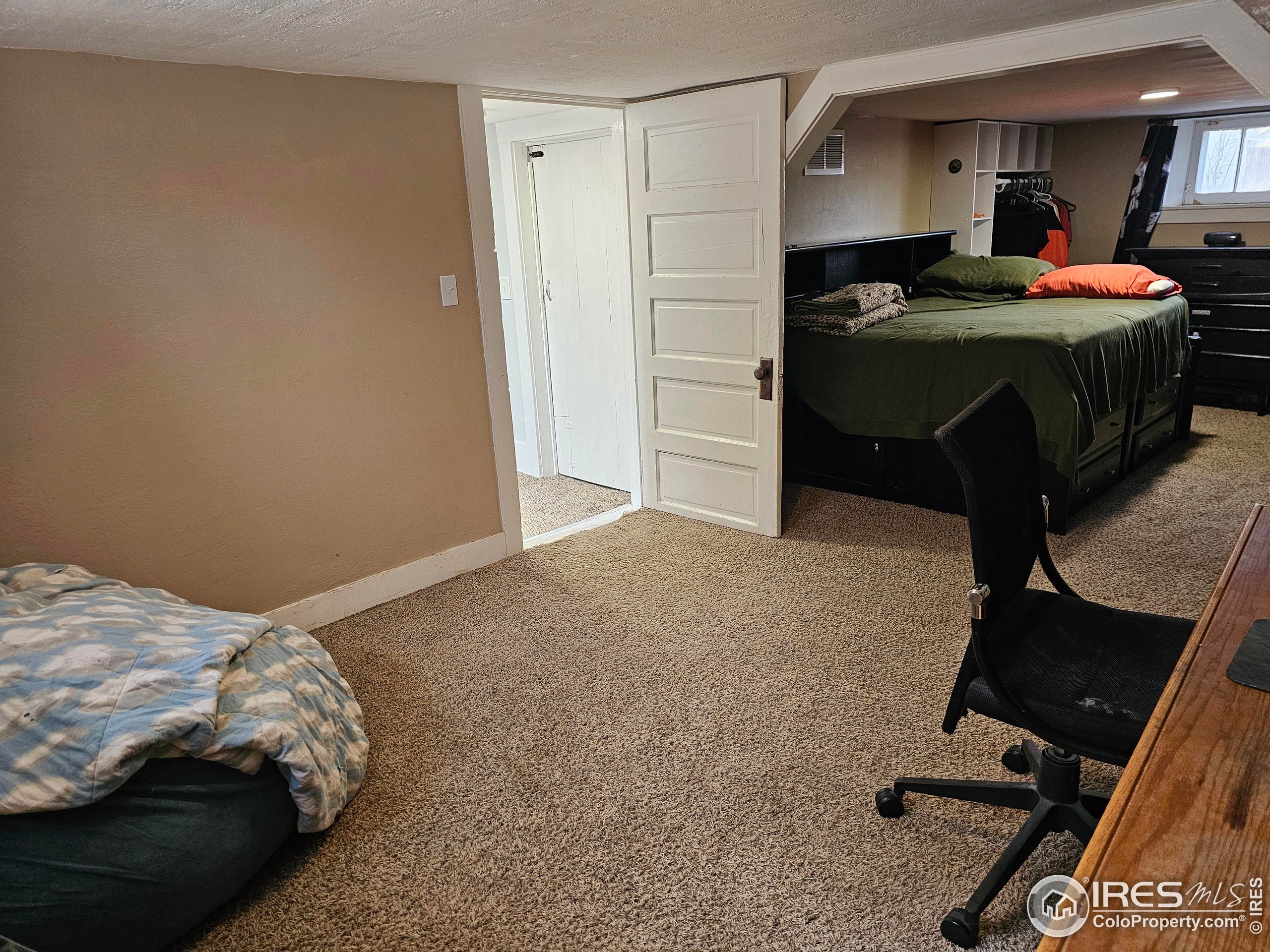 704 South 3rd Avenue Sterling, CO 80751 - Photo 27 of 35 a bedroom with a bed and a mirror