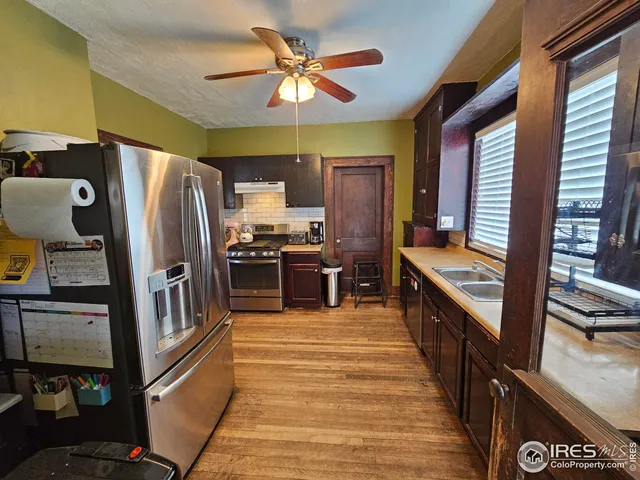 a kitchen with stainless steel appliances a refrigerator a stove a sink and dishwasher