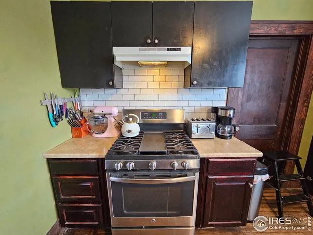 a stove top oven sitting inside of a kitchen