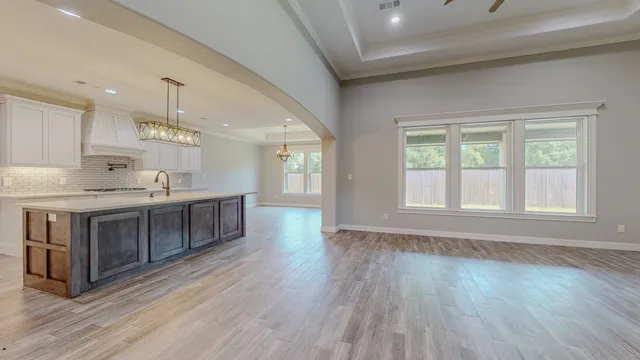a kitchen with a sink and chandelier
