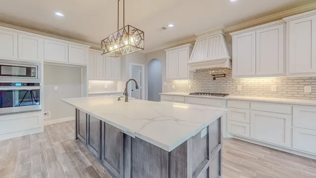 a kitchen with a stove and cabinets