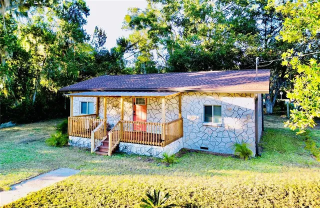 a view of a backyard with a garden and entertaining space