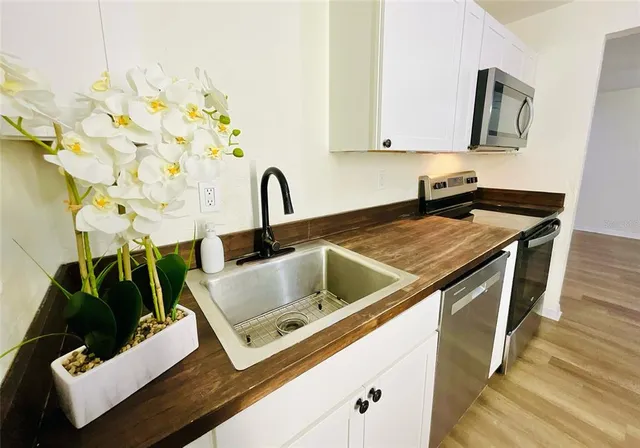 a kitchen with stainless steel appliances granite countertop a sink and a stove