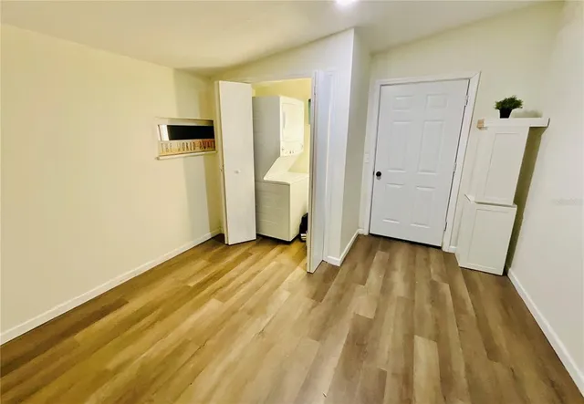 a view of a room with wooden floor and chair