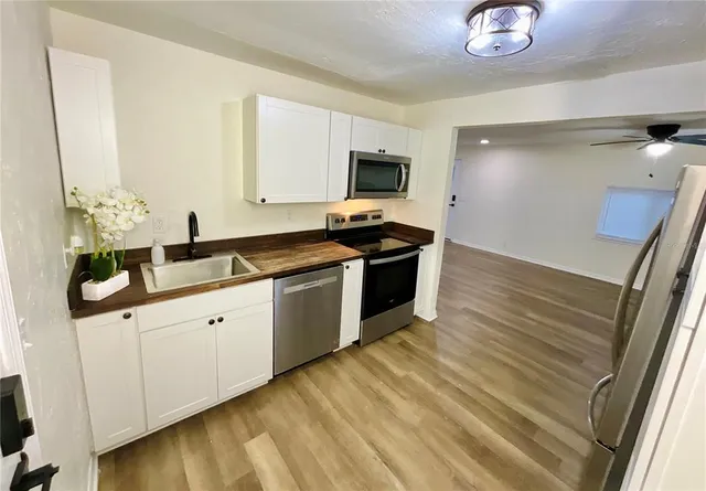 a kitchen with granite countertop a sink and cabinets